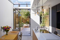 Modern open kitchen with skylight and garden access