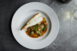 Cod fillet on its side with a vegetable sauce