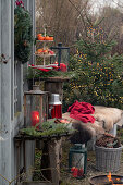 Christmas arrangement with lantern, etagere and bench with animal fur