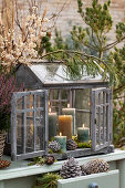 Mini greenhouse with burning candles