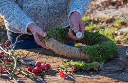 Wreath of moss, ornamental apples and mistletoe