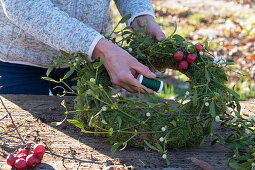 Wreath of moss, ornamental apples and mistletoe