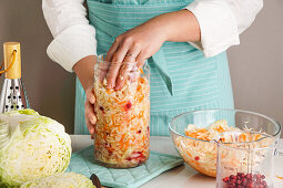 Fermented cabbage being transfered to a glass jar