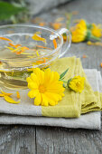 Marigold tea (Calendula officinalis), with fresh flowers and petals