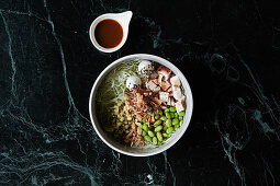 A healthy Bowl with chicken, quail eggs and edamame