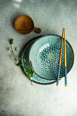 Spring table setting with first leaves and flowers of cherry tree served on the modern concrete table