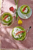 Pea cream soup with whipped cream and Parma ham
