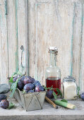 Homemade plum liqueur, cane sugar, and a baking tin with fresh plums