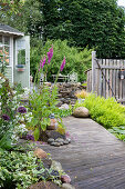 Wooden footbridge with stones and plants in the garden