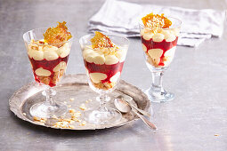 Coconut parfait with strawberry sauce and caramel nut brittle