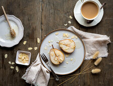 Poached pears with honey and almond flakes