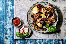 Grilled chicken thighs with sauce and fresh radish
