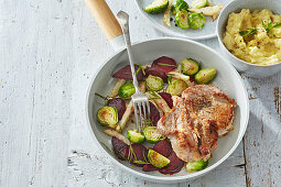 Pork steak with roasted vegetables and celery root puree