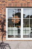 View from sunny terrace into a living room, with a star decoration on terrace door