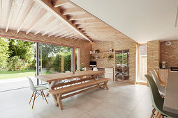 Modern open living room with window front to the garden