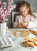 Little smilling girl preparing easter coockies