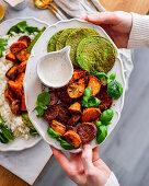 Baked sweet potatoes with breadcrumbs and spinach pancakes