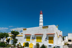 Typical houses on the beach and lighthouse, at Olhao, Faro, Portugal