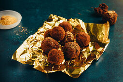 Truffle pralines with gold dust on gold paper