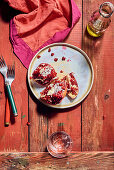 Broken open pomegranates on a plate