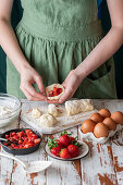 Strawberry dumplings being made: dumplings being filled and shaped