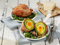 Avocado with egg wrapped in bacon for Easter