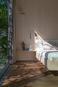 Bedroom with open, floor-to-ceiling sliding door