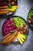 Healthy bowl with tofu, red cabbage, edamame and green beans