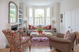 Living room with upholstered furniture, built-in cabinets, and fireplace