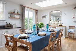 Dining table with church chairs, in the background patio access