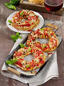 Bagel pizza with salami, peppers and jalapeno