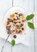 Crumble doughnuts with custard filling and sweet cherries