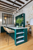 Kitchen counter with petrol-coloured front as work and dining table