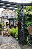 View through open wrought-iron gate onto patio area