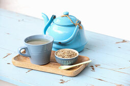 A Cup of Siberian Ginseng-Taiga Root Tea with Loose Tea and a Tea Pot