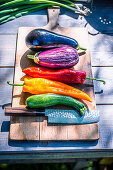 Summer vegetables with knife on wooden board