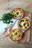 Quiche with wild herbs, vine shoots and broccoli