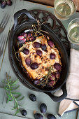 Baked feta cheese with roasted grapes and rosemary