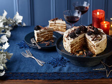 Layered cookie cake with coffee cream and blackberries