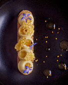 Honey dessert with white chocolate and blue blossoms (close-up)