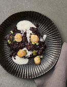 Black risotto with vermouth foam and scallops