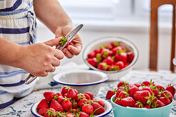 Chopping fresh strawberries for jam