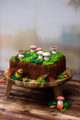 Autumnal pistachio berry cake decorated with meringue mushrooms