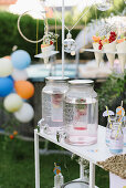 Party buffet with lemonade, fruits in paper cones on a hanging shelf