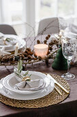 Christmas table with round raffia placemats and white plates