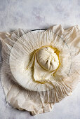 Homemade ricotta in a cheesecloth