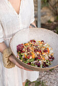 Summer leaf salad with cherries, apricots and roasted hazelnuts