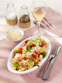 Italian farfalle salad with mozzarella, ham, and nuts