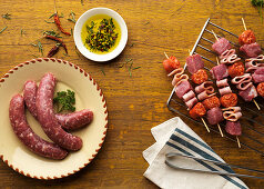 Raw meat skewers and fresh sausage