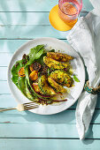 Curried courgette wedges with lentil and dandelion salad